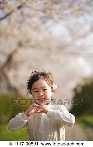 Smiling Japanese girl with joined hands View Large Photo Image Stock Image - Smiling Japanese girl with joined hands . Fotosearch