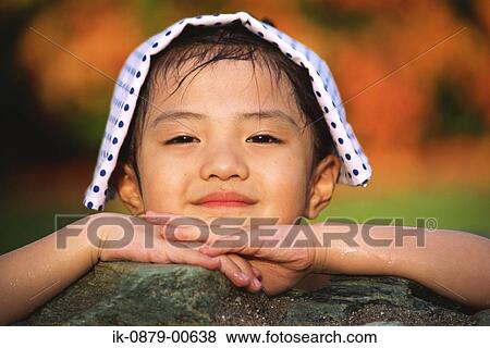 Smiling Japanese girl with towel on her head View Large Photo Image Stock Photo - Smiling Japanese girl with towel on her head. Fotosearch