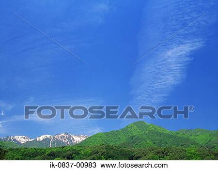 Stock Image - Snow-Capped Mountains against Blue Sky. Fotosearch
