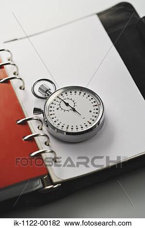 Stock Image - Studio shot of an open notebook with spectacles. Fotosearch