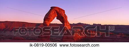 Stock Photograph - Sunset Light on Arched Rocky Cliffs. Fotosearch