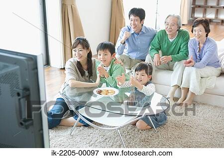 Three generation family watching television together View Large Photo Image Stock Photo - Three generation family watching television together. Fotosearch