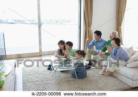 Three generation family watching television together View Large Photo Image Stock Photo - Three generation family watching television together. Fotosearch