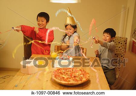 Stock Photograph - Three Kids Popping Poppers at a Birthday. Fotosearch