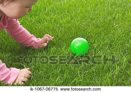 Toddler baby playing with ball View Large Photo Image Stock Photography - Toddler baby playing with ball. Fotosearch