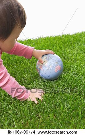 Toddler baby playing with globe View Large Photo Image Picture - Toddler baby playing with globe. Fotosearch