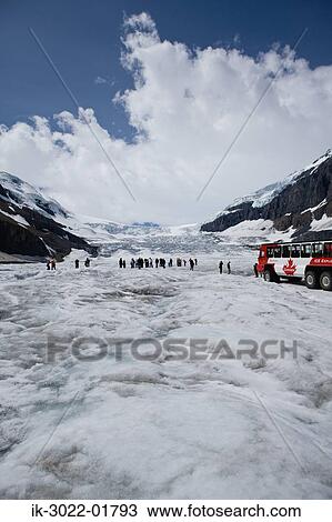 Stock Image - Tourists at Columbia Ice Field in Canada. Fotosearch