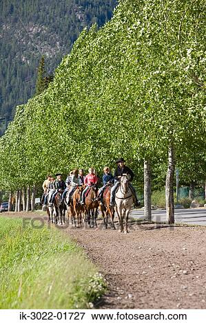 Tourists Riding Horses at Alberta in Canada View Large Photo Image Stock Photo - Tourists Riding Horses at Alberta in Canada. Fotosearch
