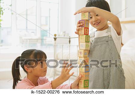 Two Children Playing with Alphabet Blocks View Large Photo Image Stock Photograph - Two Children Playing with Alphabet Blocks. Fotosearch
