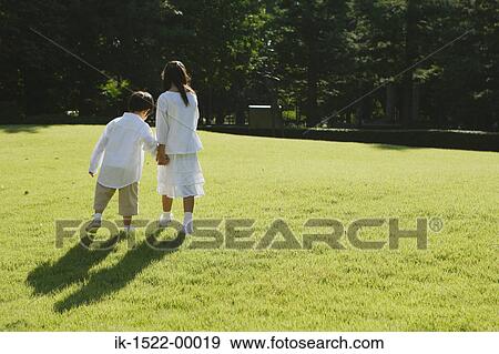 Stock Photo - Two Children Walking Together. Fotosearch
