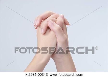Stock Image - Two Hands Interlocked Together in Studio. Fotosearch