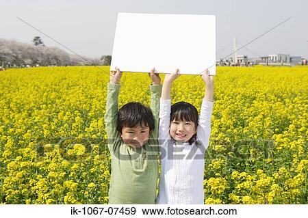 Two Japanese children holding white cardboard View Large Photo Image Stock Photo - Two Japanese children holding white cardboard. Fotosearch