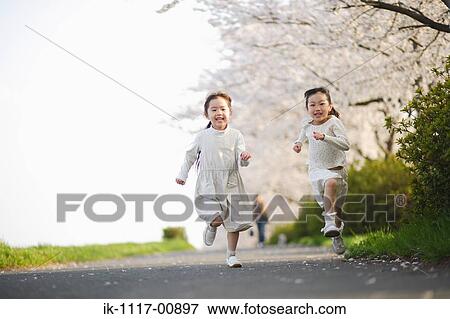 Two Japanese girls running on road View Large Photo Image Stock Photo - Two Japanese girls running on road. Fotosearch