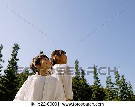 Stock Image - Two Kids Looking Up. Fotosearch