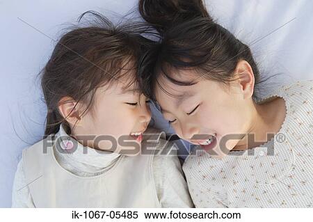 Two smiling girls having fun together View Large Photo Image Stock Photography - Two smiling girls having fun together. Fotosearch