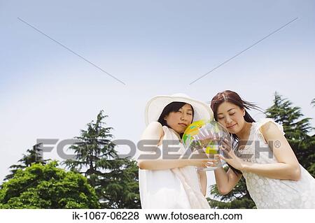 Two young women holding ball View Large Photo Image Stock Photo - Two young women holding ball. Fotosearch