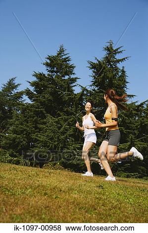 Stock Photo - Two Young Women Jogging. Fotosearch