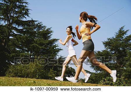 Stock Photo - Two Young Women Jogging. Fotosearch