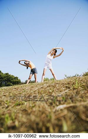 Two Young Women Stretching View Large Photo Image Stock Image - Two Young Women Stretching. Fotosearch