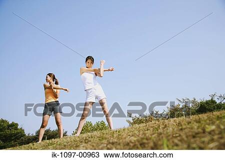 Two Young Women Stretching View Large Photo Image Stock Image - Two Young Women Stretching. Fotosearch