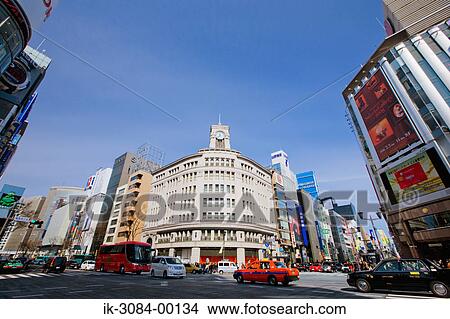Vehicles intersecting at street with shopping malls View Large Photo Image Picture - Vehicles intersecting at street with shopping malls. Fotosearch