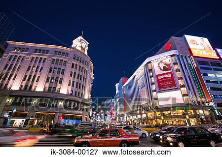 Vehicles on road with illuminated buildings in nighttime View Large Photo Image Stock Photo - Vehicles on road with illuminated buildings in nighttime. Fotosearch