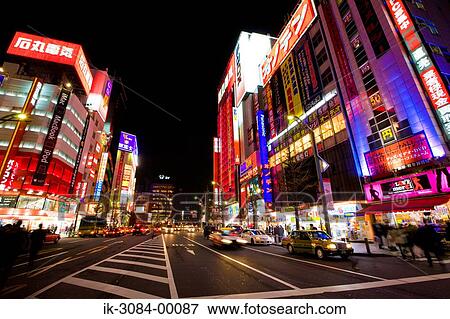 Stock Photo - Vehicles outside buildings in commercial district. Fotosearch