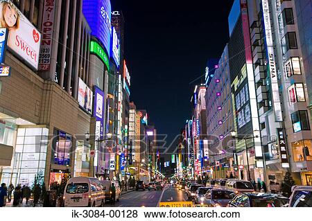 Stock Photo - Vehicles outside buildings in commercial district. Fotosearch