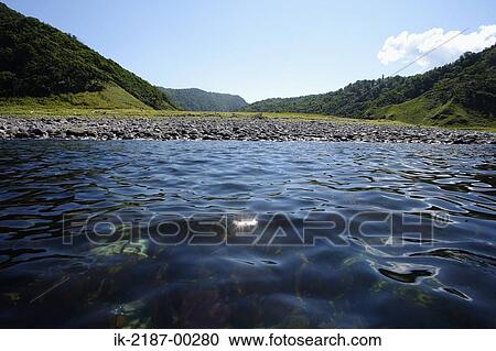 Stock Image - View of Ripples with Pebbles. Fotosearch