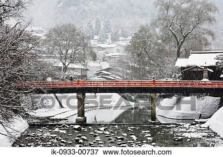 Stock Photo - View of Snow Covered Bridge and Trees in Japan. Fotosearch