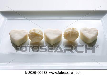 Stock Image - White Chocolates in Heart Shape. Fotosearch