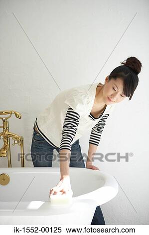 Woman cleaning bathtub in bathroom View Large Photo Image Stock Photography - Woman cleaning bathtub in bathroom. Fotosearch