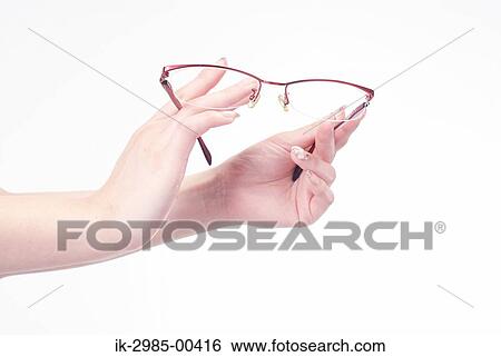 Stock Photograph - Woman Hands Holding Eyeglasses . Fotosearch