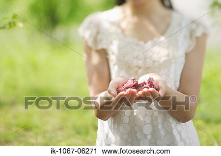 Stock Image - Woman holding flowers. Fotosearch