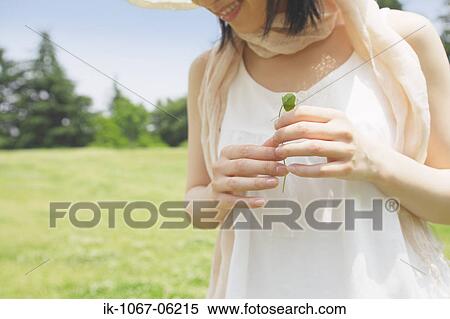 Stock Photography - Woman holding leaf. Fotosearch