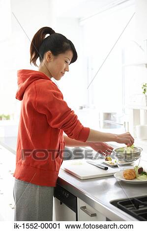 Woman preparing food in kitchen View Large Photo Image Stock Image - Woman preparing food in kitchen. Fotosearch