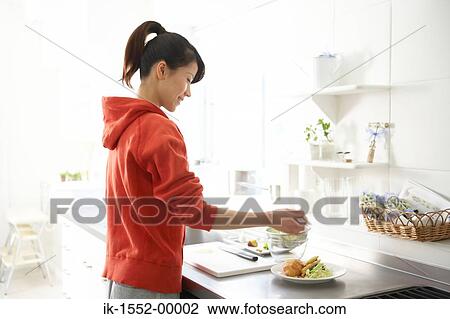 Woman preparing food in kitchen View Large Photo Image Stock Image - Woman preparing food in kitchen. Fotosearch