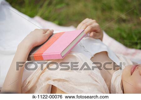 Stock Photograph - Woman sleeping with book. Fotosearch