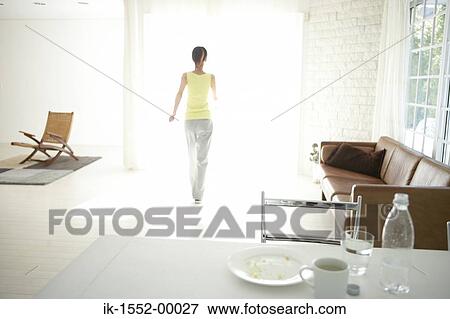 Stock Photo - Woman walking in a room. Fotosearch