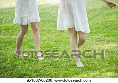 Women walking in park together View Large Photo Image Stock Photograph - Women walking in park together. Fotosearch