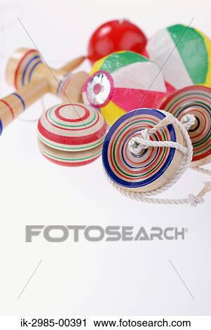 Stock Image - Wooden Yoyo and Kendama, and Paper Balloons. Fotosearch