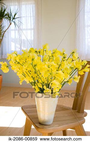 Stock Photo - Yellow Flower Vase on Chair. Fotosearch