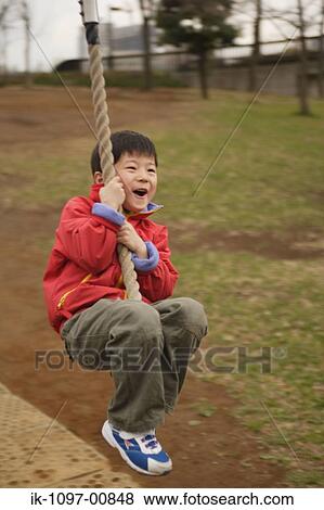 Young Boy Swinging from Rope View Large Photo Image Stock Photo - Young Boy Swinging from Rope. Fotosearch
