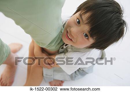 Stock Image - Young Child Hugging Mother's Leg. Fotosearch