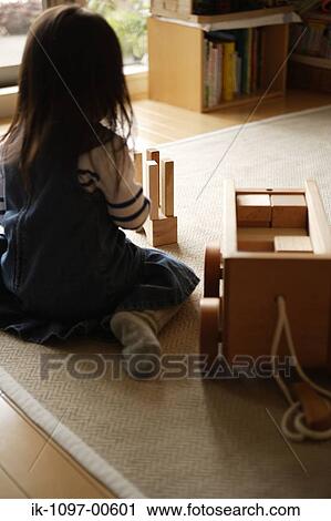 Stock Image - Young Girl Playing with Wooden Blocks. Fotosearch