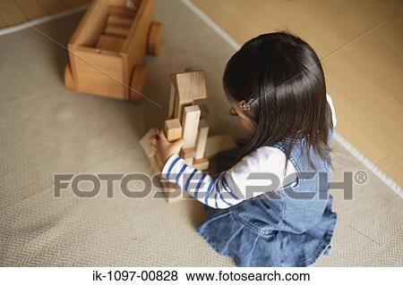 Stock Photo - Young Girl Playing with Wooden Blocks. Fotosearch