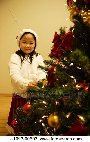 Young Girl Putting on Christmas Tree Ornaments View Large Photo Image Stock Image - Young Girl Putting on Christmas Tree Ornaments. Fotosearch
