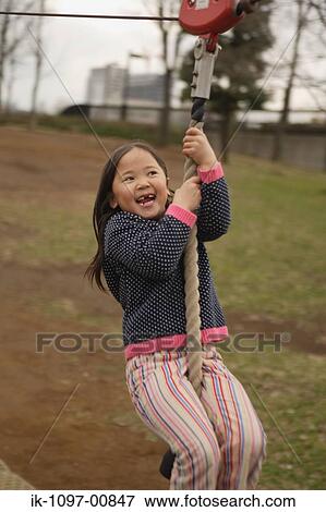 Young Girl Swinging from Rope View Large Photo Image Stock Photo - Young Girl Swinging from Rope. Fotosearch
