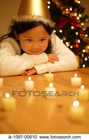 Stock Image - Young Girl Watching Candles. Fotosearch