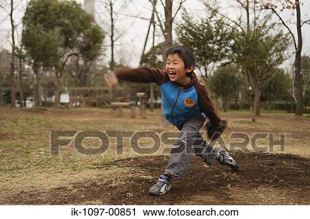 Stock Image - Young Japanese Boy Throwing Baseball. Fotosearch